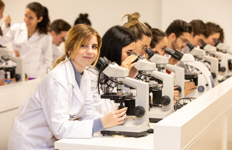 Estudiantes de Medac con un microscopio